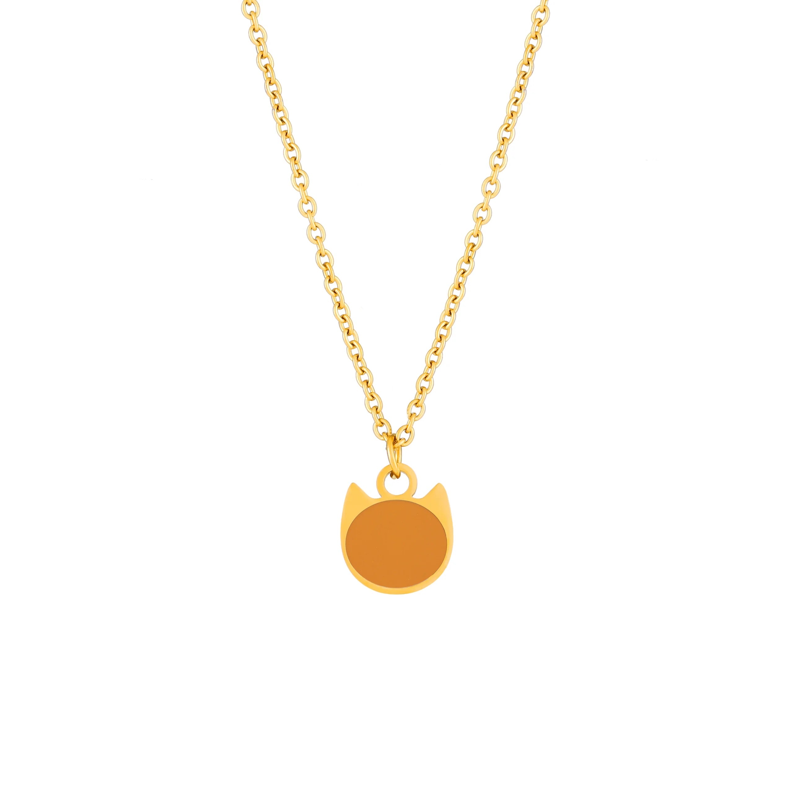 A gold chain necklace with a minimalist cat-shaped pendant featuring a blank, solid orange-brown face, shown against a plain white background.