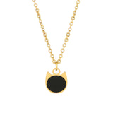 A gold chain necklace with a pendant shaped like a cat's head, featuring a solid black circular center and a polished gold border, shown against a plain white background.