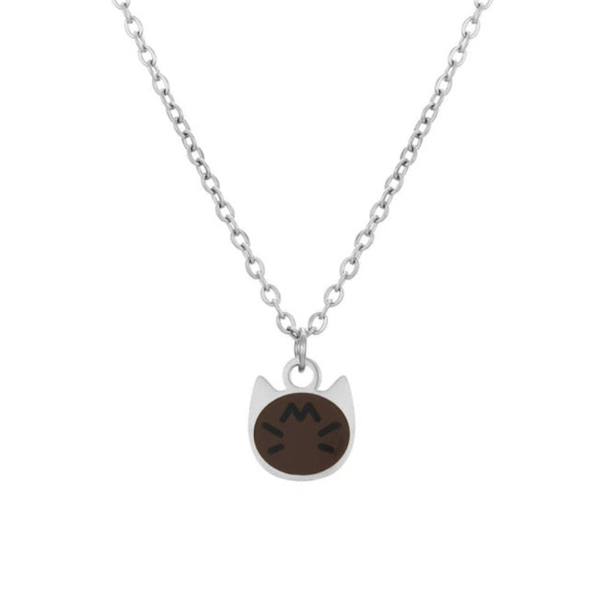 A silver chain necklace with a small cat-shaped pendant featuring a dark brown oval face and white ears, shown on a plain white background.
