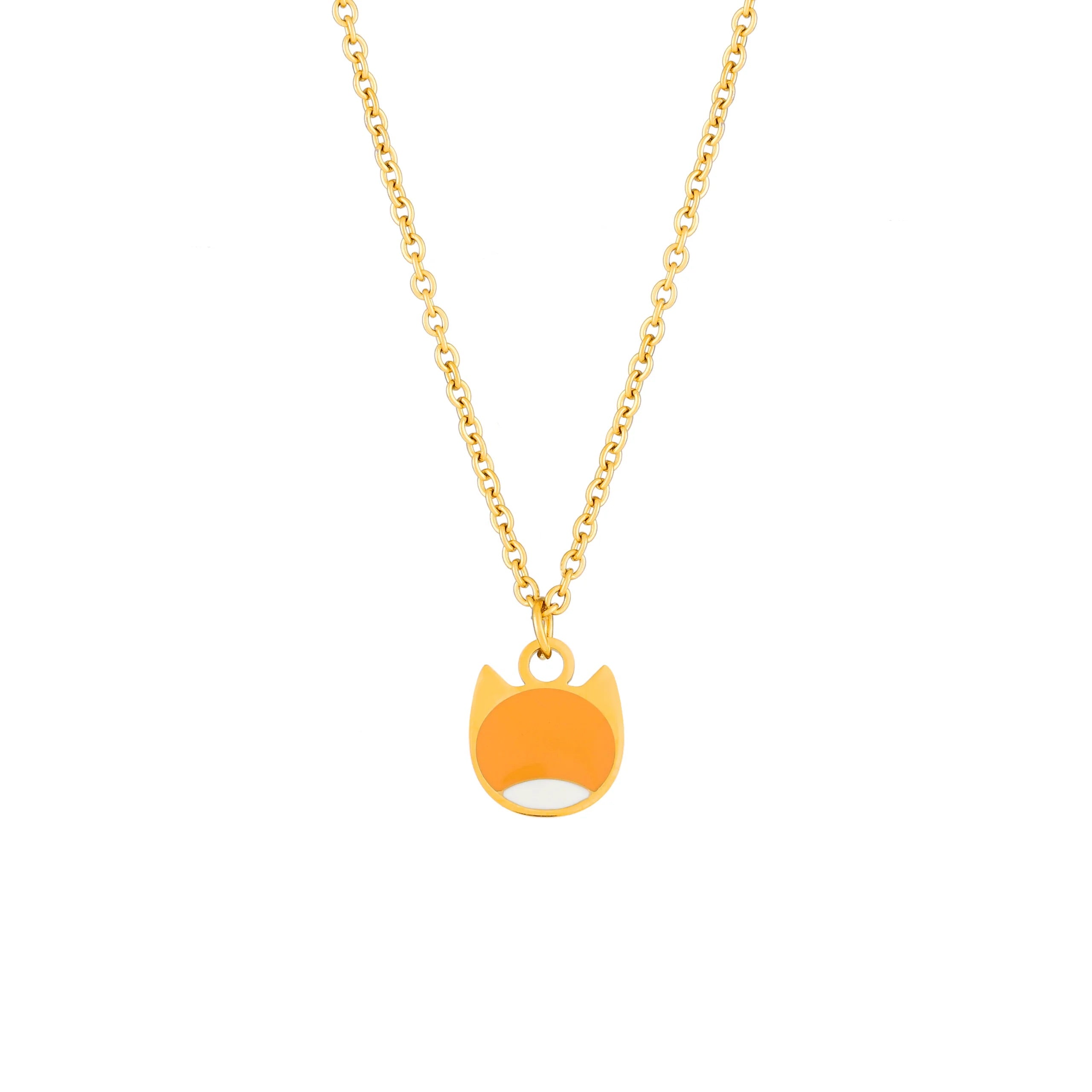A gold chain necklace with a small pendant shaped like a cat's face, featuring a bright orange enamel fill and a white accent at the bottom, shown on a plain white background.