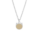 Gold necklace with a round pendant on a light beige background