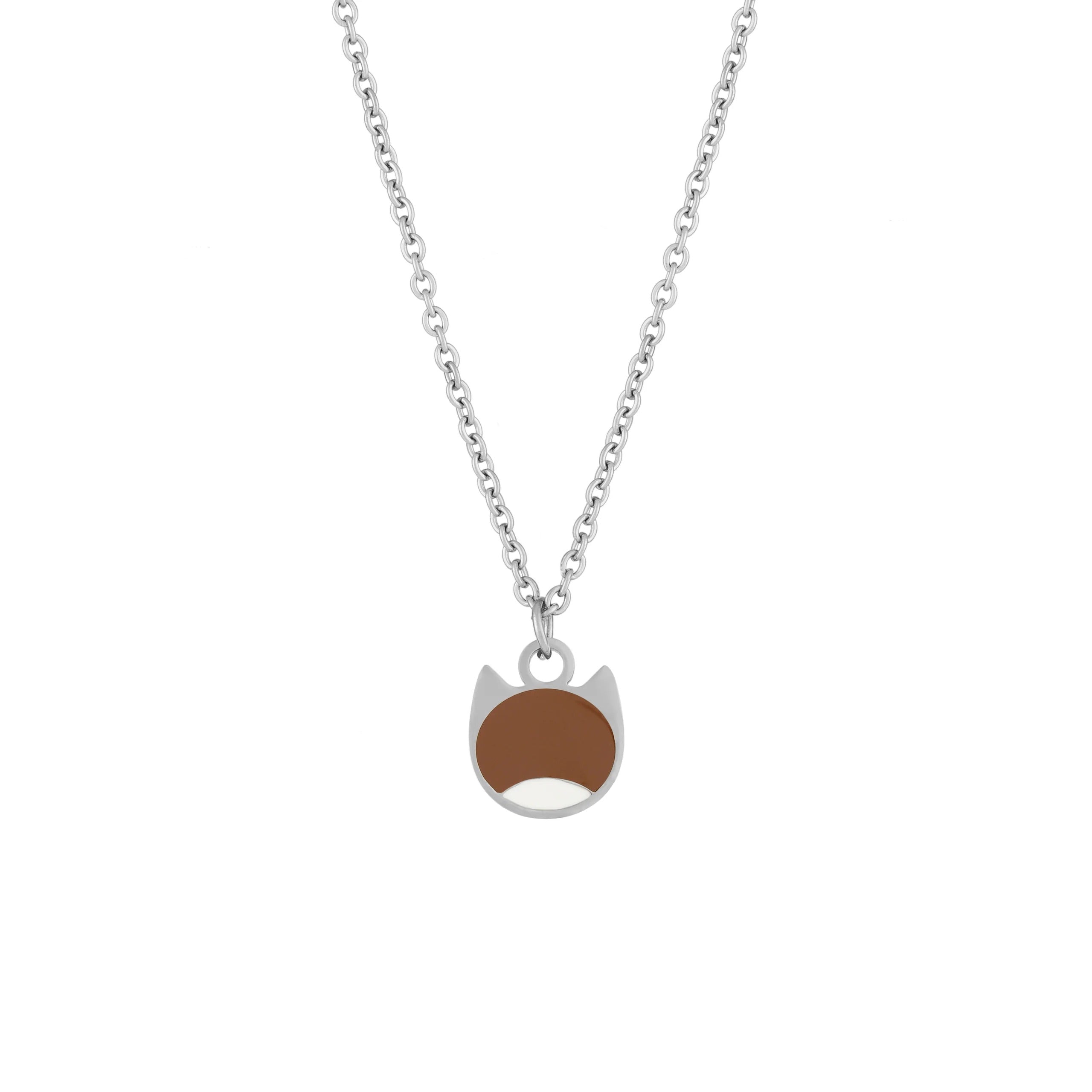 A silver chain necklace with a small pendant shaped like a cat face, featuring a brown oval for the nose and mouth area, shown on a plain white background.