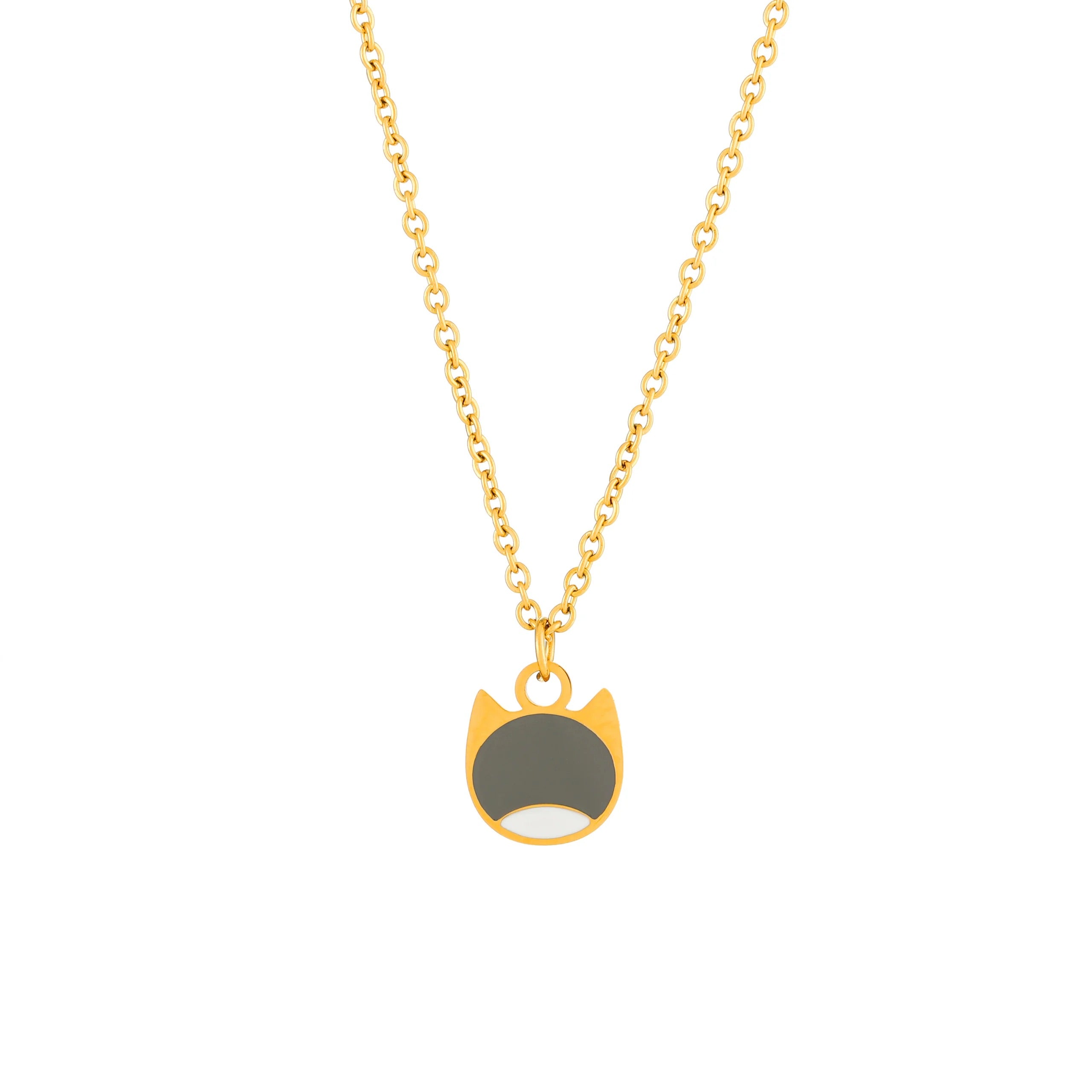 A gold chain necklace featuring a minimalist cat-face pendant with a dark gray center and a small white accent at the bottom, shown against a plain white background.