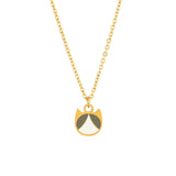 A gold chain necklace with a minimalist cat-shaped pendant featuring gold, white, and gray enamel details, shown against a plain white background.