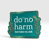 A square enamel pin with a teal background and gold border, featuring the white text 'do no harm but take no shit' with decorative gold botanical illustrations on the sides.