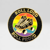 A circular enamel pin featuring roller skates over a rainbow background with the words 'ROLL LOUD' at the top and 'ROLL PROUD' at the bottom, shown on a light gray gradient background.