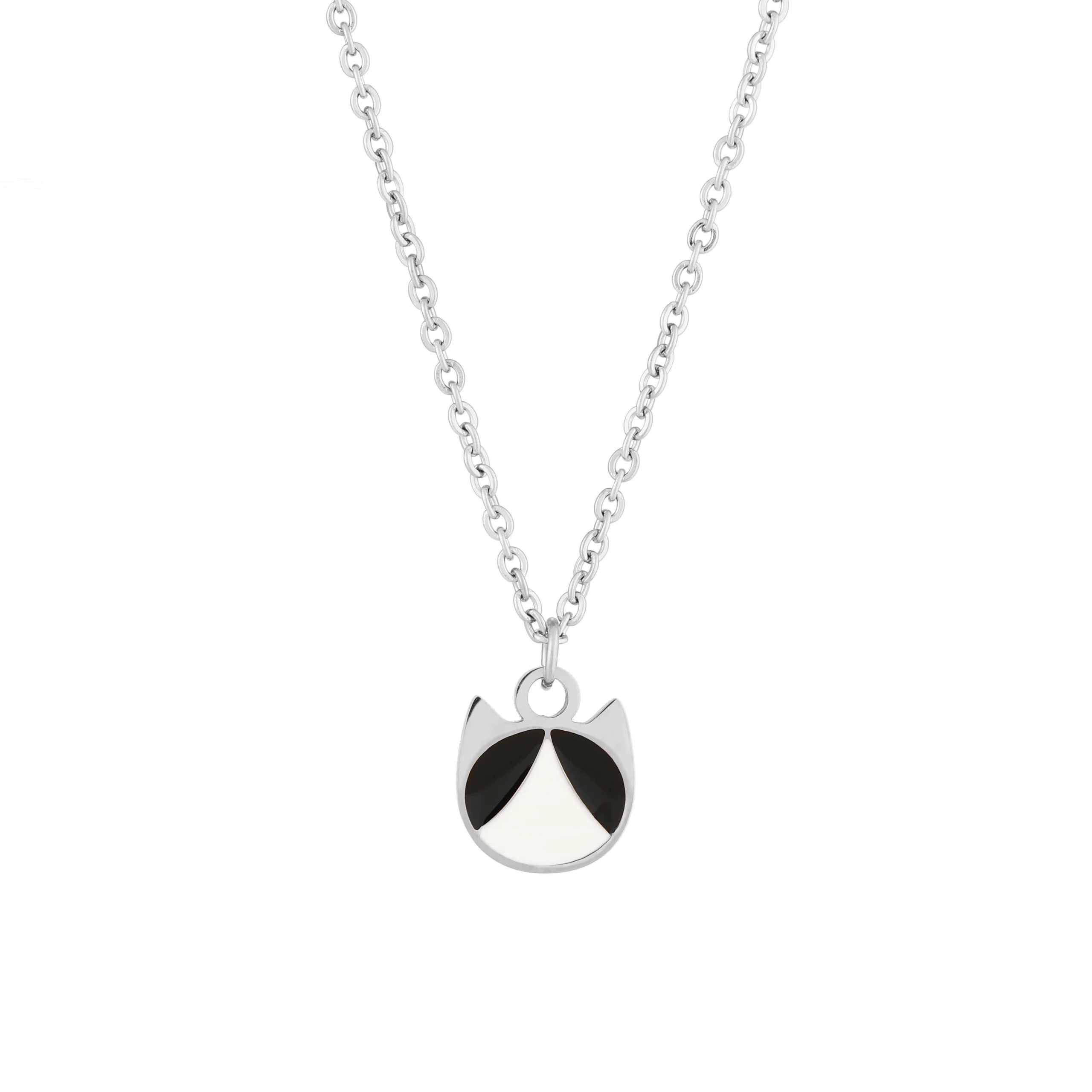 A silver chain necklace featuring a minimalist pendant shaped like a cat's head, detailed with black and white enamel sections, set against a plain white background.