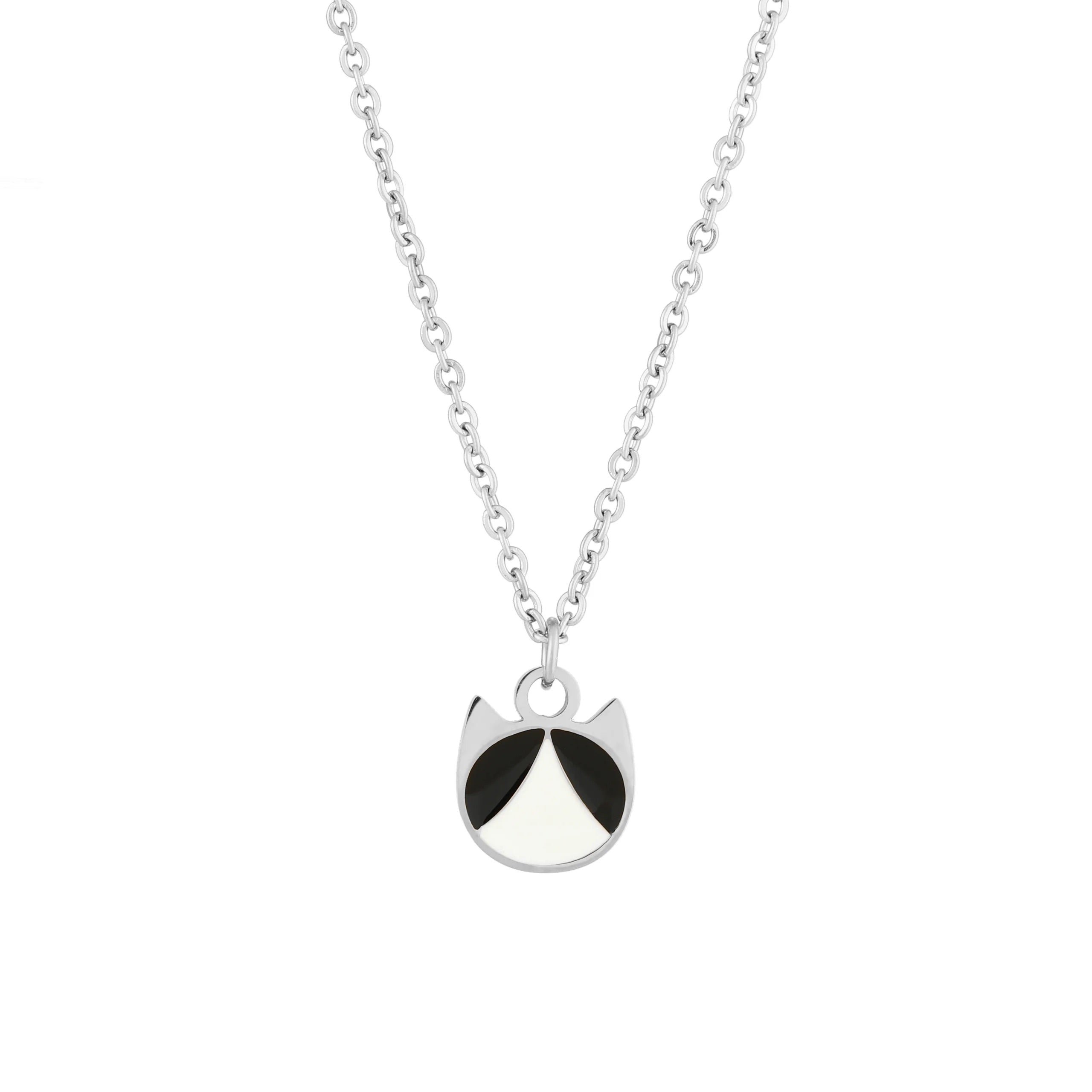 A silver chain necklace featuring a minimalist pendant shaped like a cat's head, detailed with black and white enamel sections, set against a plain white background.