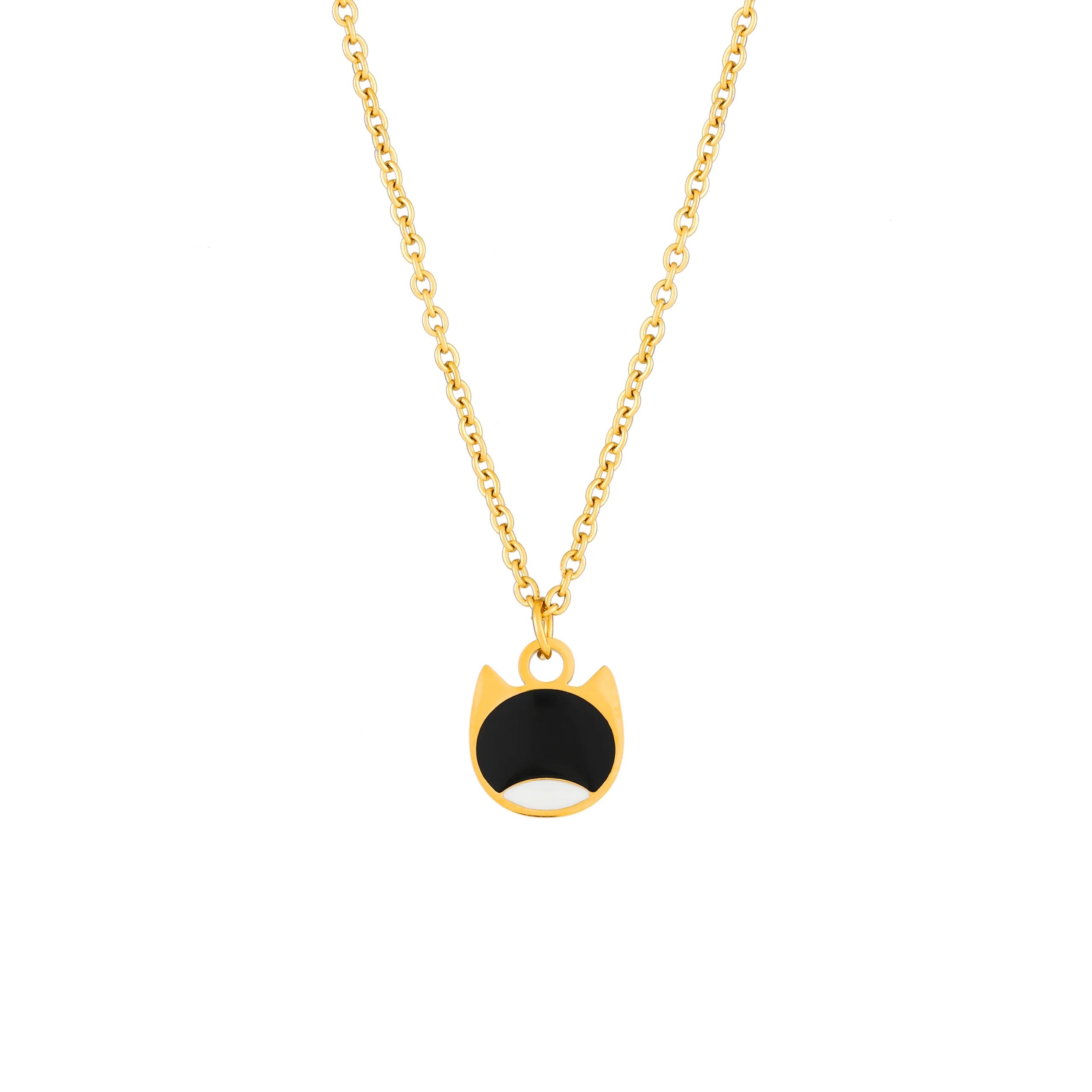 A gold chain necklace with a cat-face pendant featuring a black enamel center and white enamel lower half, shown on a plain white background.