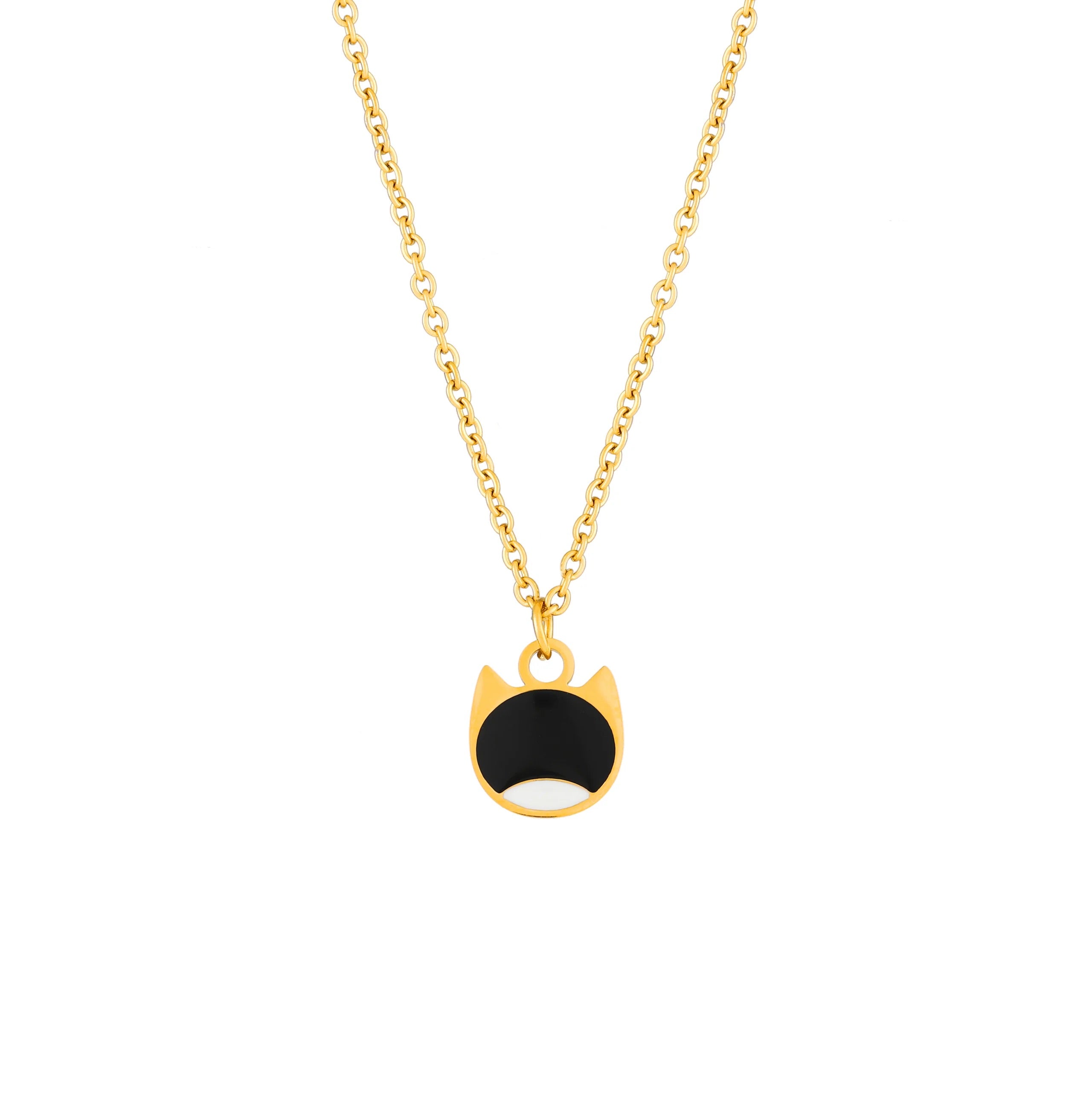 A gold chain necklace with a cat-face pendant featuring a black enamel center and white enamel lower half, shown on a plain white background.