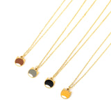 Four gold-tone cat-shaped pendant necklaces with different colored paws (brown, gray, black, and yellow) arranged diagonally on a white background.