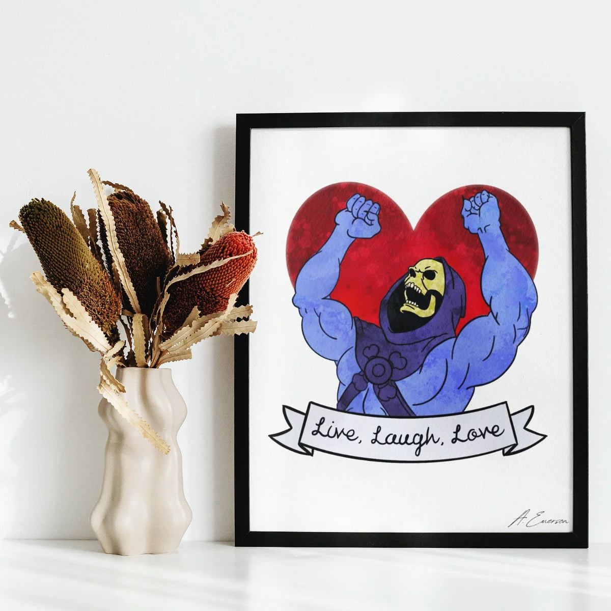 Framed artwork of a muscular character with a red heart and 'Live, Laugh, Love' text on a white wall.