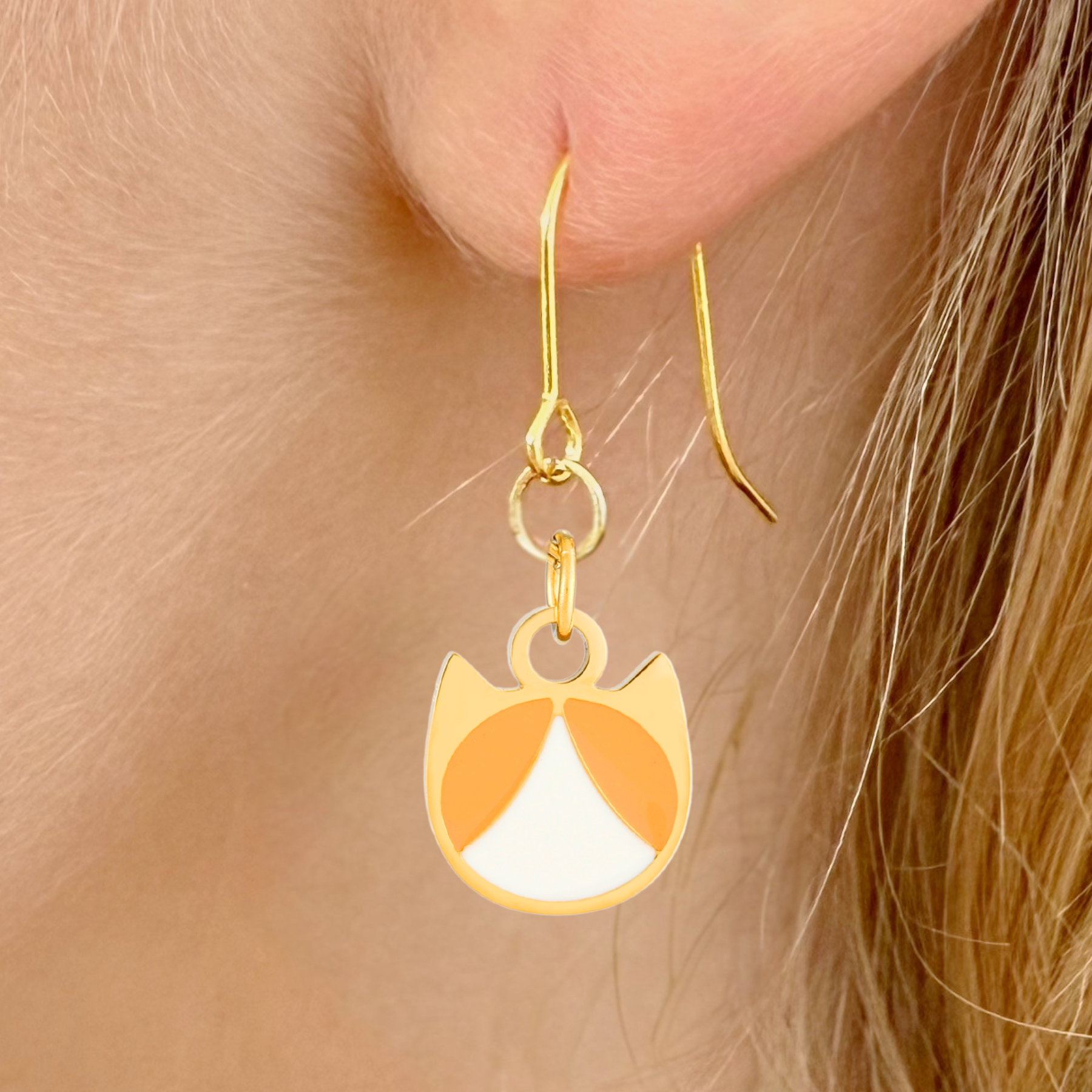 Tuxedo minimalist cat earrings in silver or gold with a black and white tuxedo cat silhouette charm