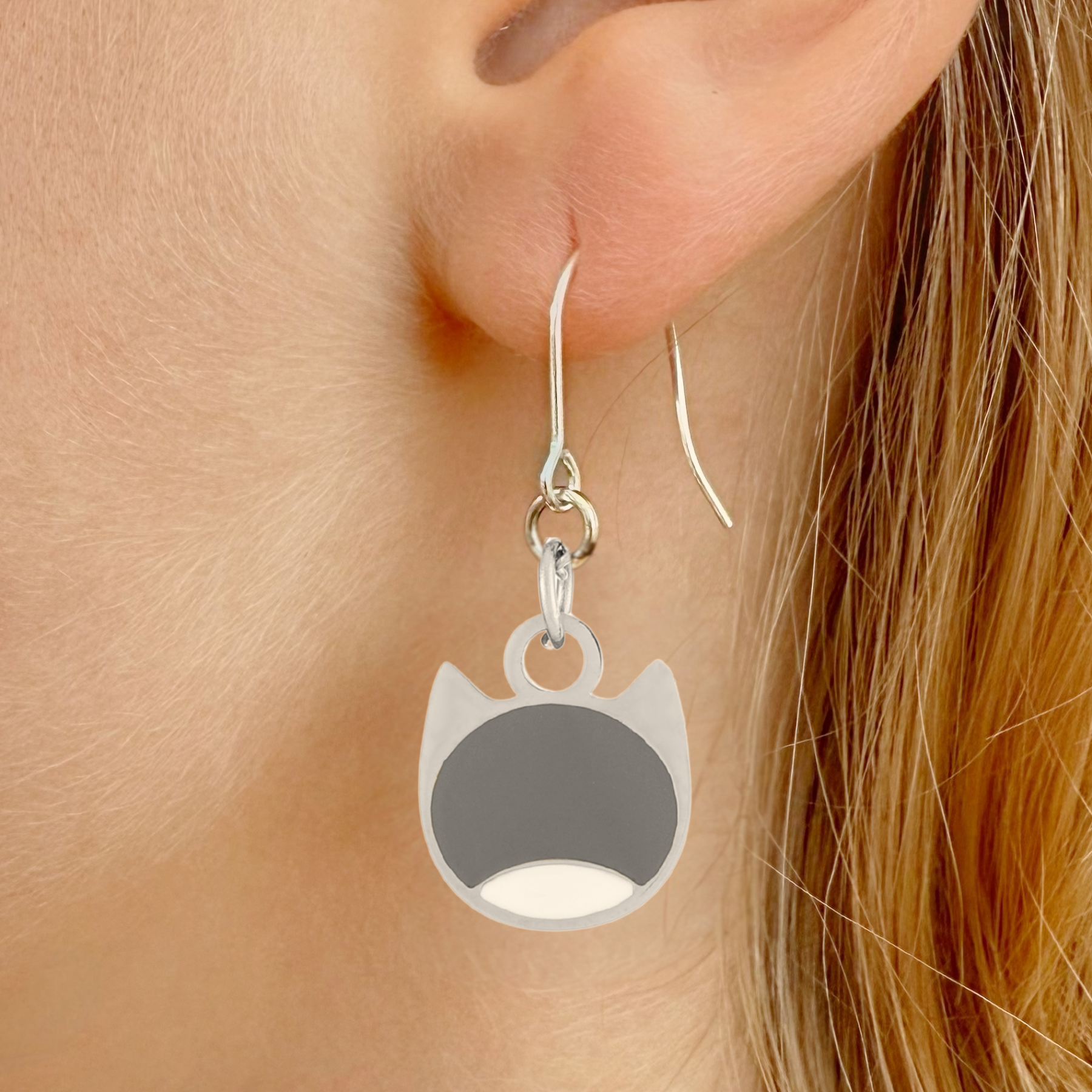 Bi-color minimalist cat earrings in silver or gold with a two-tone cat silhouette charm