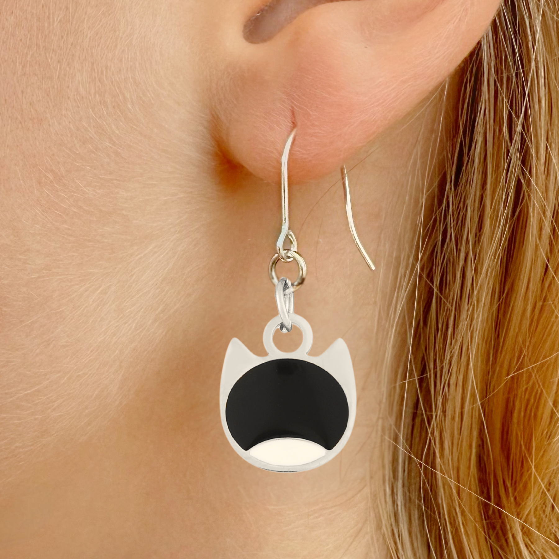 Bi-color minimalist cat earrings in silver or gold with a two-tone cat silhouette charm