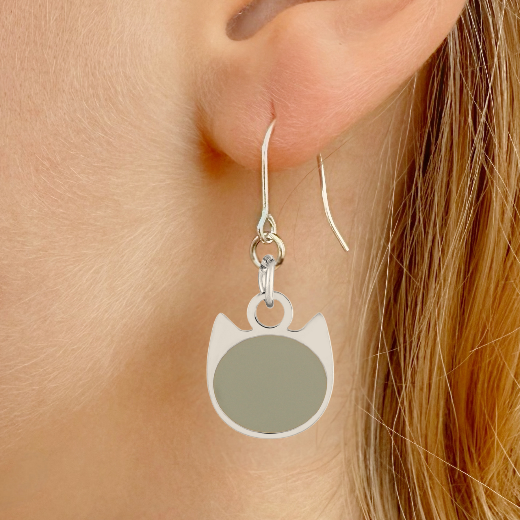 Solid minimalist cat earrings in silver or gold with a solid-color cat silhouette charm