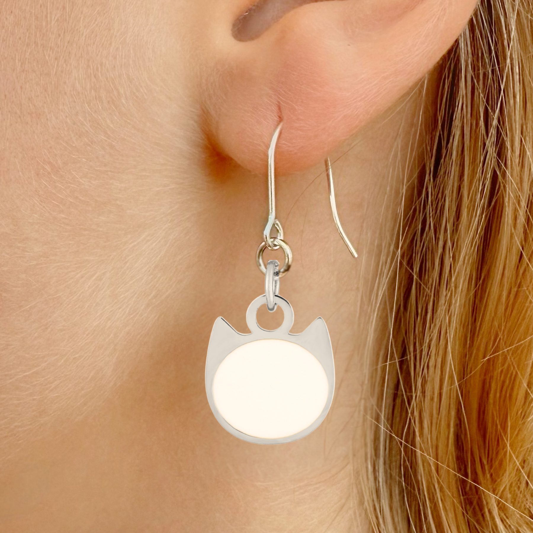 Solid minimalist cat earrings in silver or gold with a solid-color cat silhouette charm