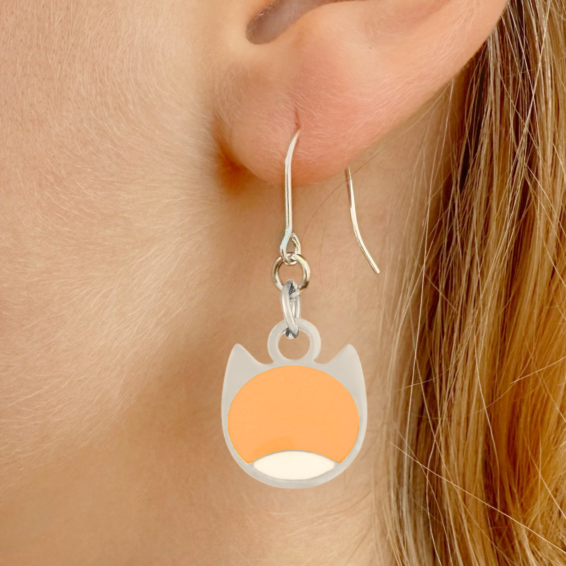 Bi-color minimalist cat earrings in silver or gold with a two-tone cat silhouette charm