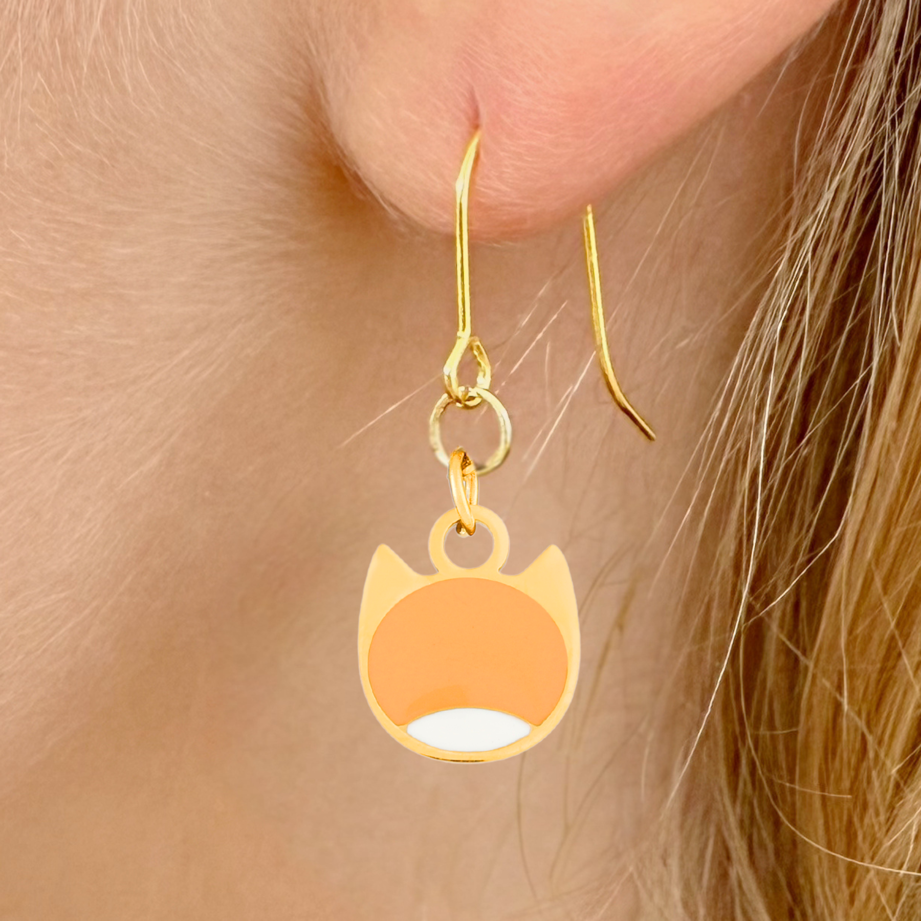 Bi-color minimalist cat earrings in silver or gold with a two-tone cat silhouette charm