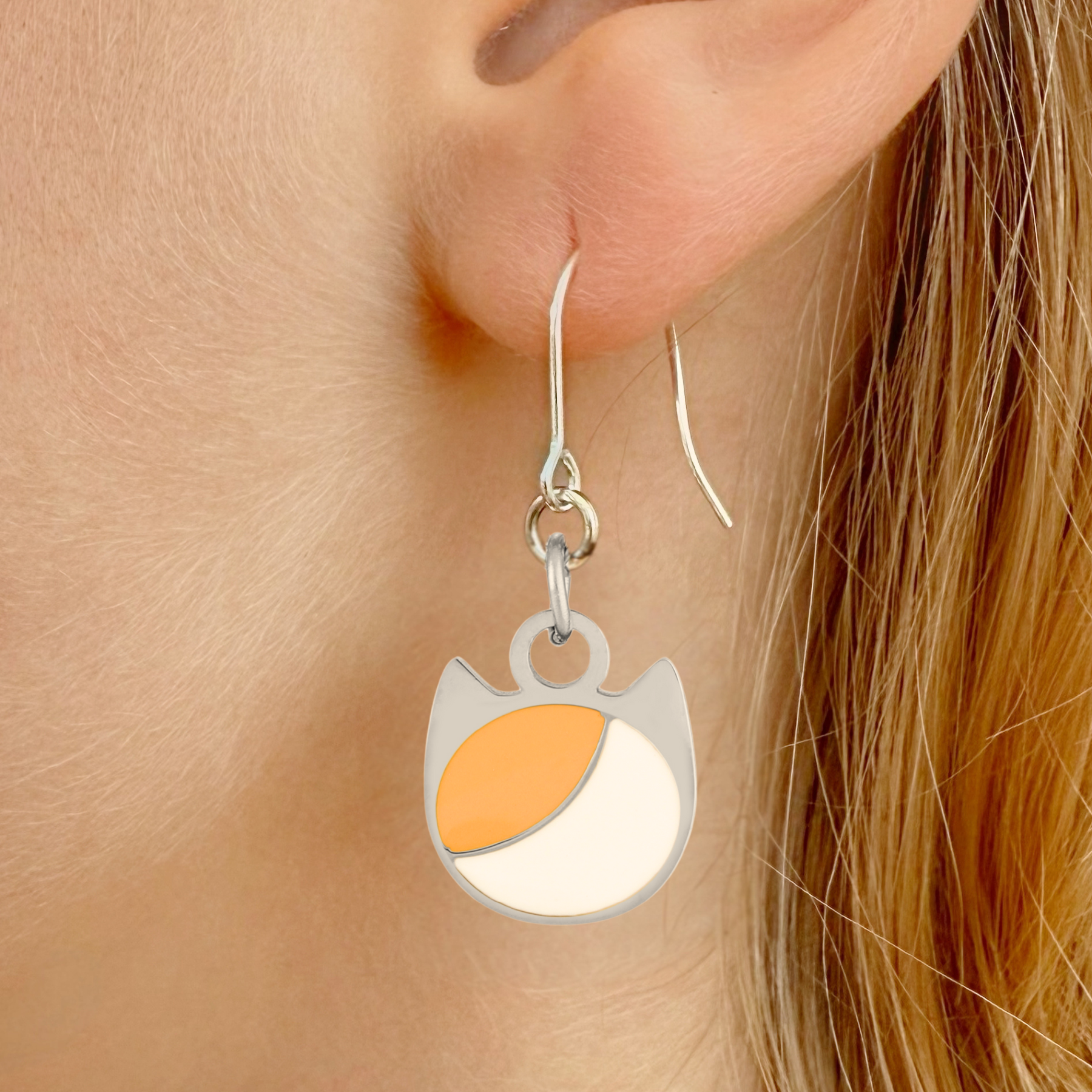 Asymmetrical minimalist cat earrings in silver or gold with an asymmetrical two-tone cat silhouette charm