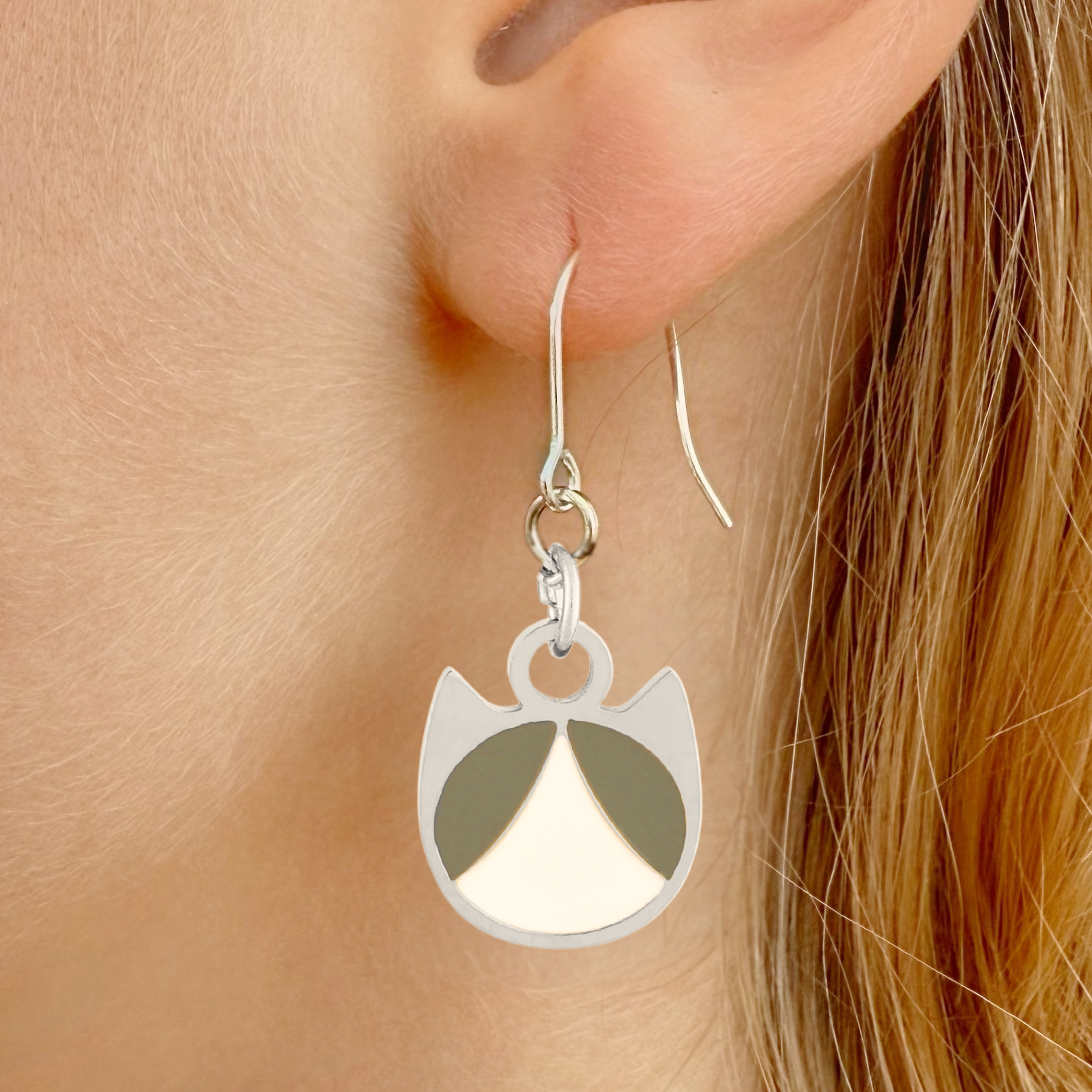 Tuxedo minimalist cat earrings in silver or gold with a black and white tuxedo cat silhouette charm
