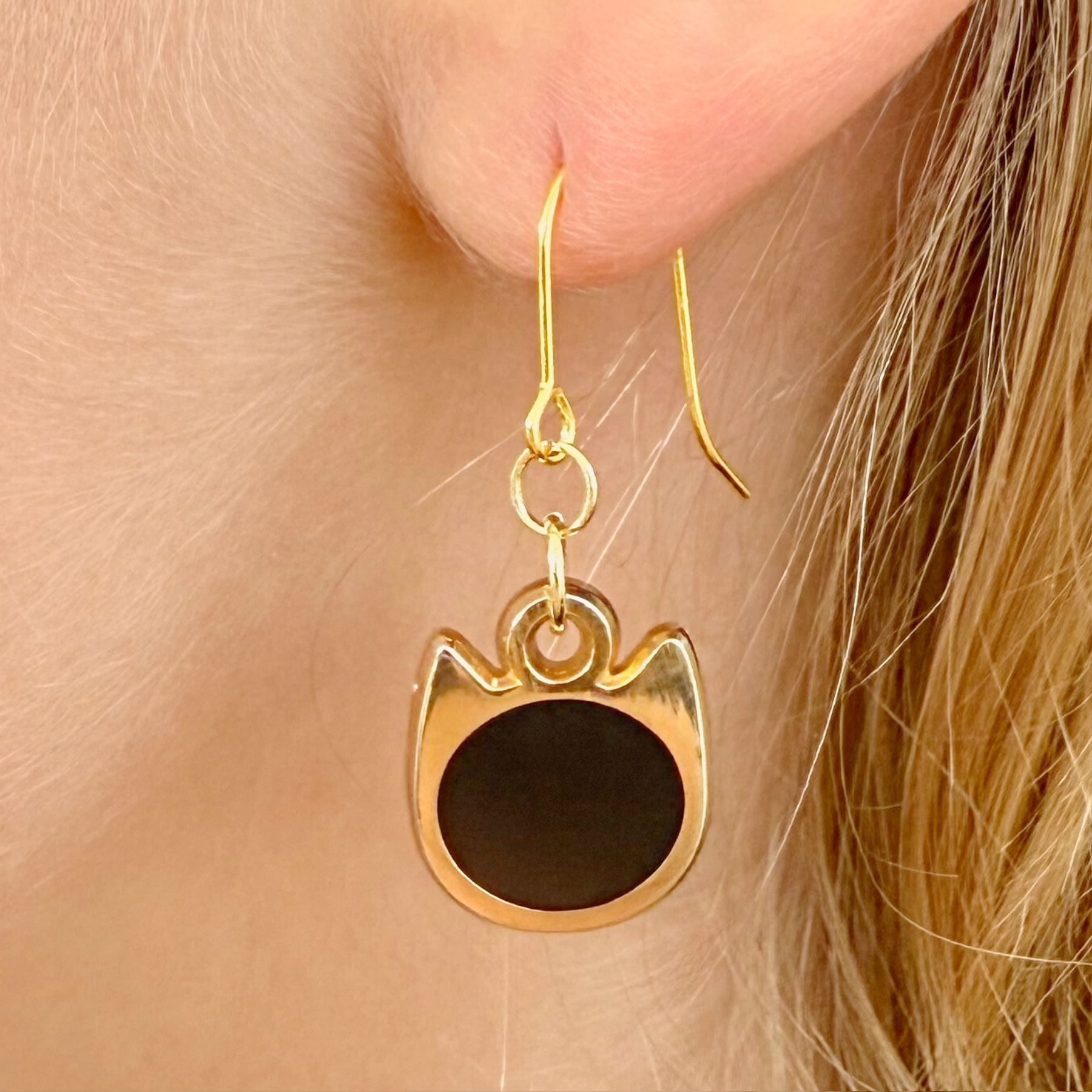 Solid minimalist cat earrings in silver or gold with a solid-color cat silhouette charm