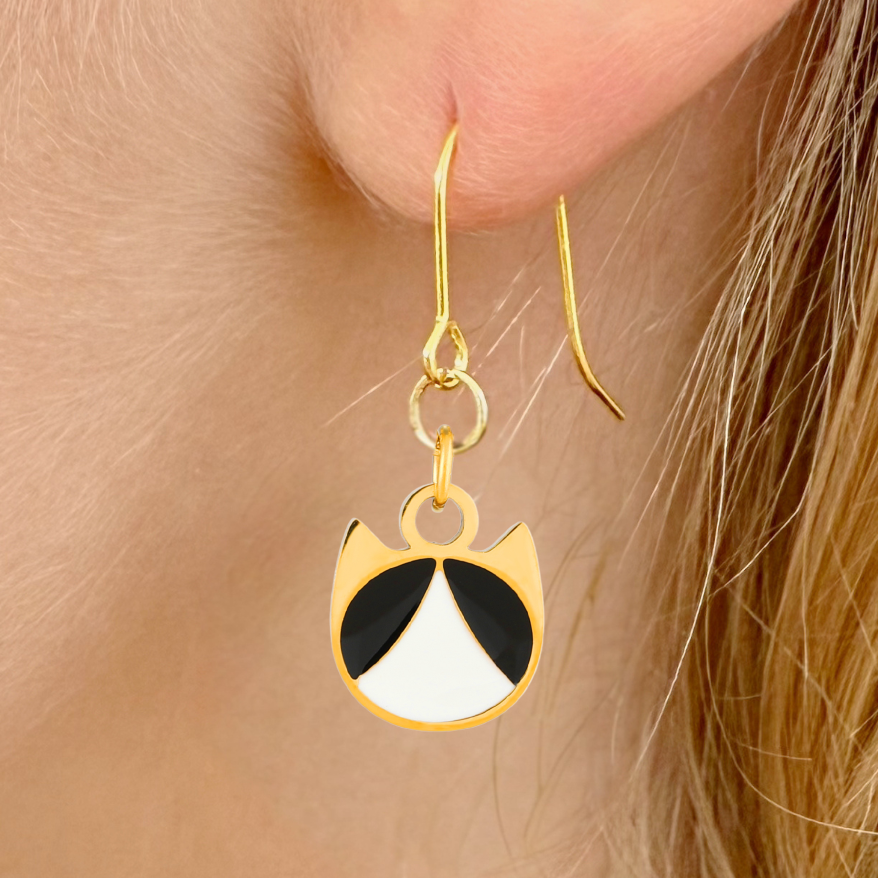 Tuxedo minimalist cat earrings in silver or gold with a black and white tuxedo cat silhouette charm