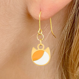 Asymmetrical minimalist cat earrings in silver or gold with an asymmetrical two-tone cat silhouette charm