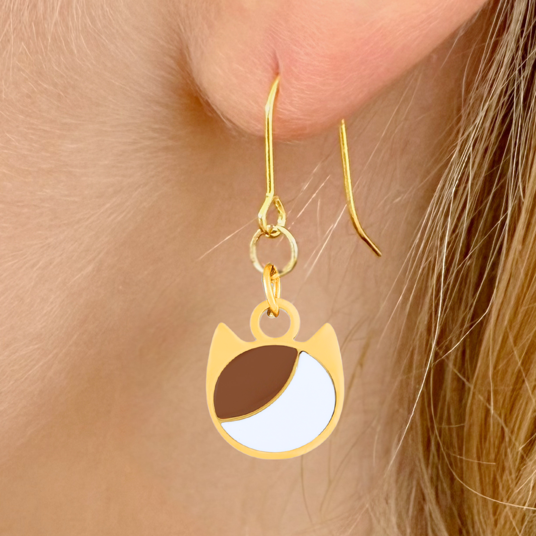 Asymmetrical minimalist cat earrings in silver or gold with an asymmetrical two-tone cat silhouette charm