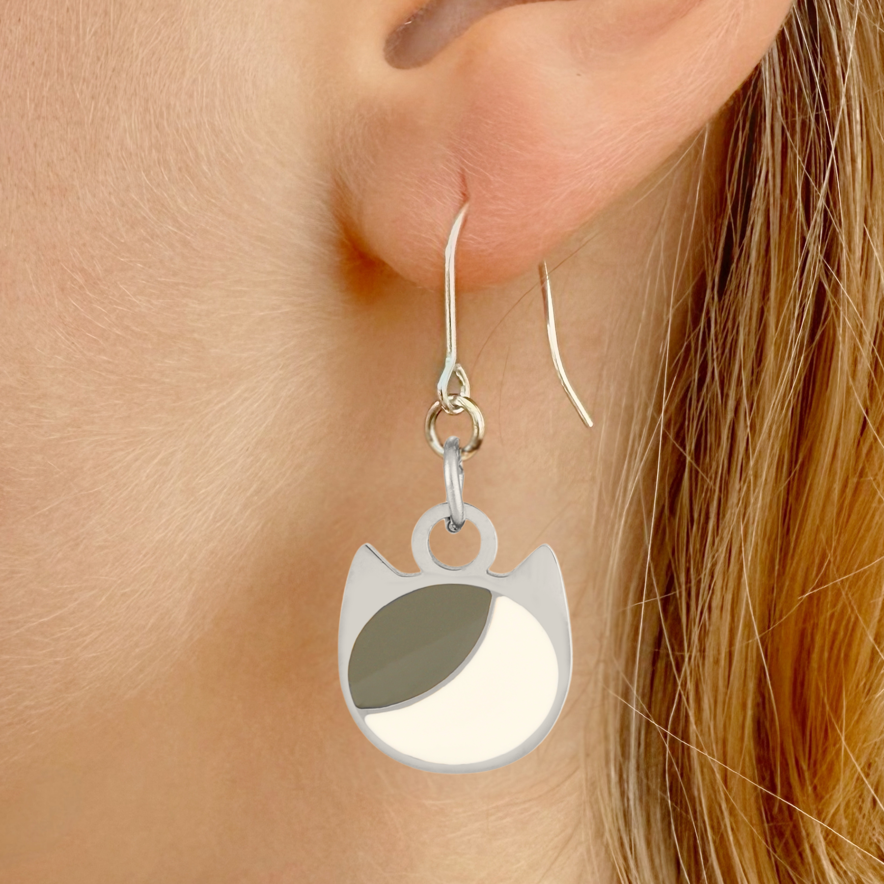 Asymmetrical minimalist cat earrings in silver or gold with an asymmetrical two-tone cat silhouette charm