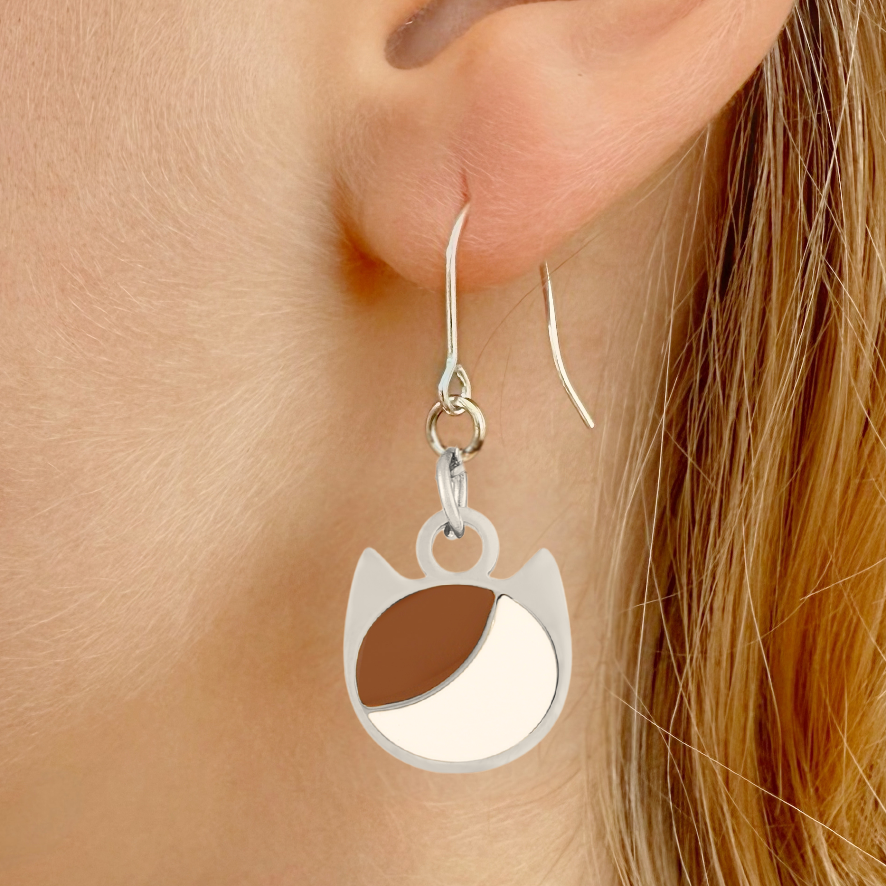 Asymmetrical minimalist cat earrings in silver or gold with an asymmetrical two-tone cat silhouette charm