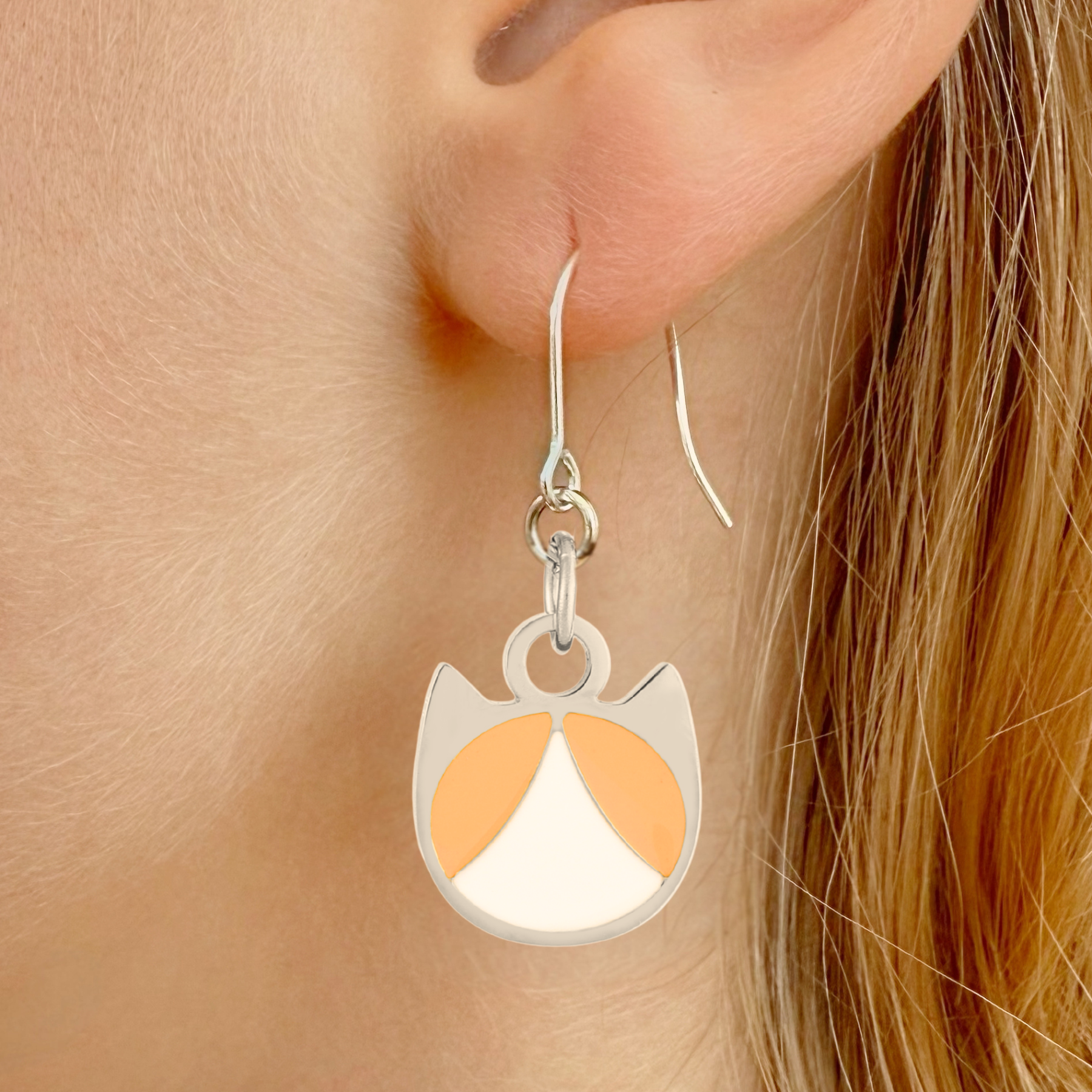 Tuxedo minimalist cat earrings in silver or gold with a black and white tuxedo cat silhouette charm
