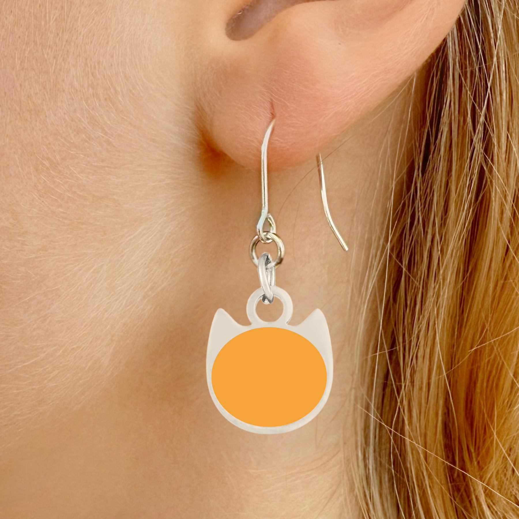 Solid minimalist cat earrings in silver or gold with a solid-color cat silhouette charm