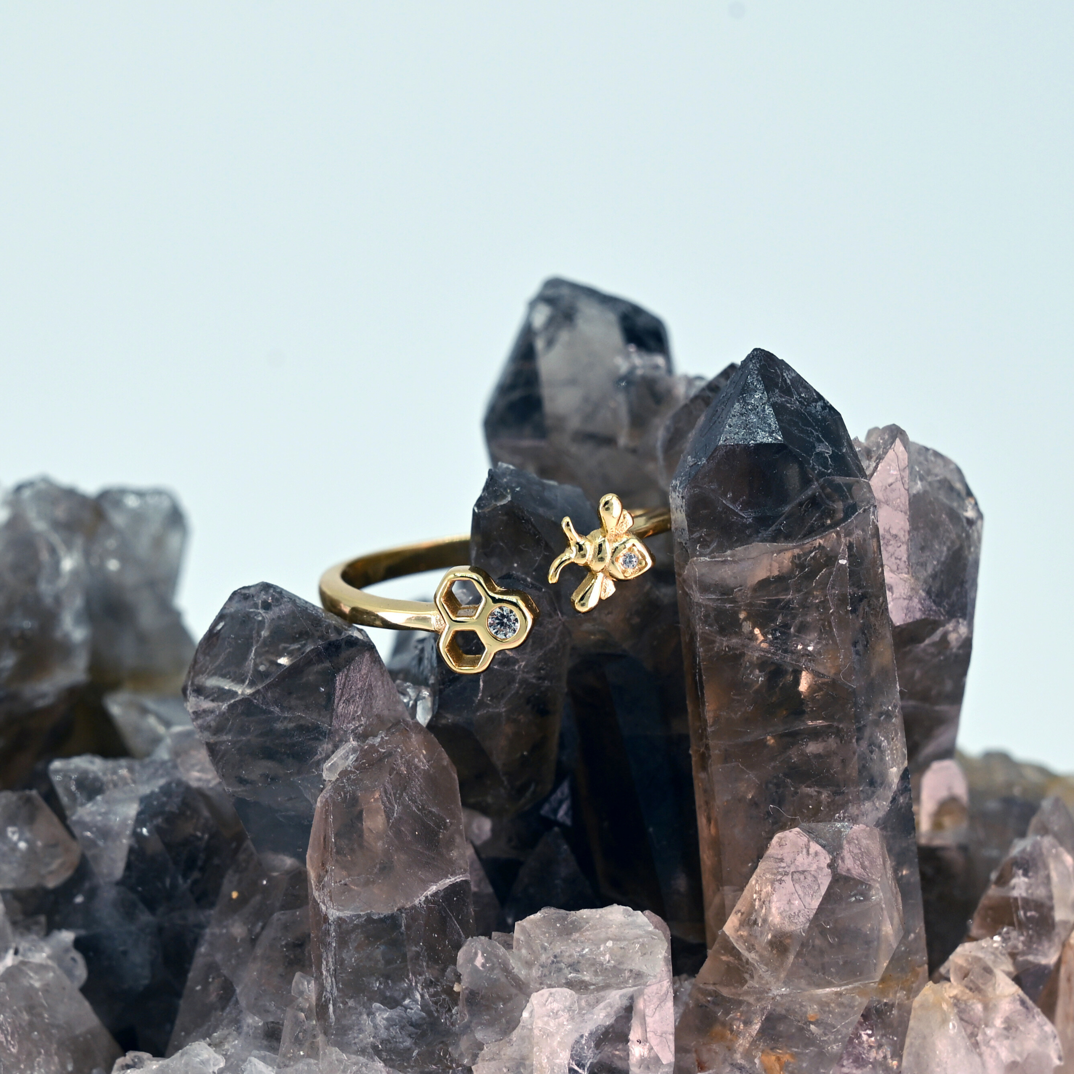 Adjustable bee and honeycomb ring in silver or gold with a bee charm and two CZ stones