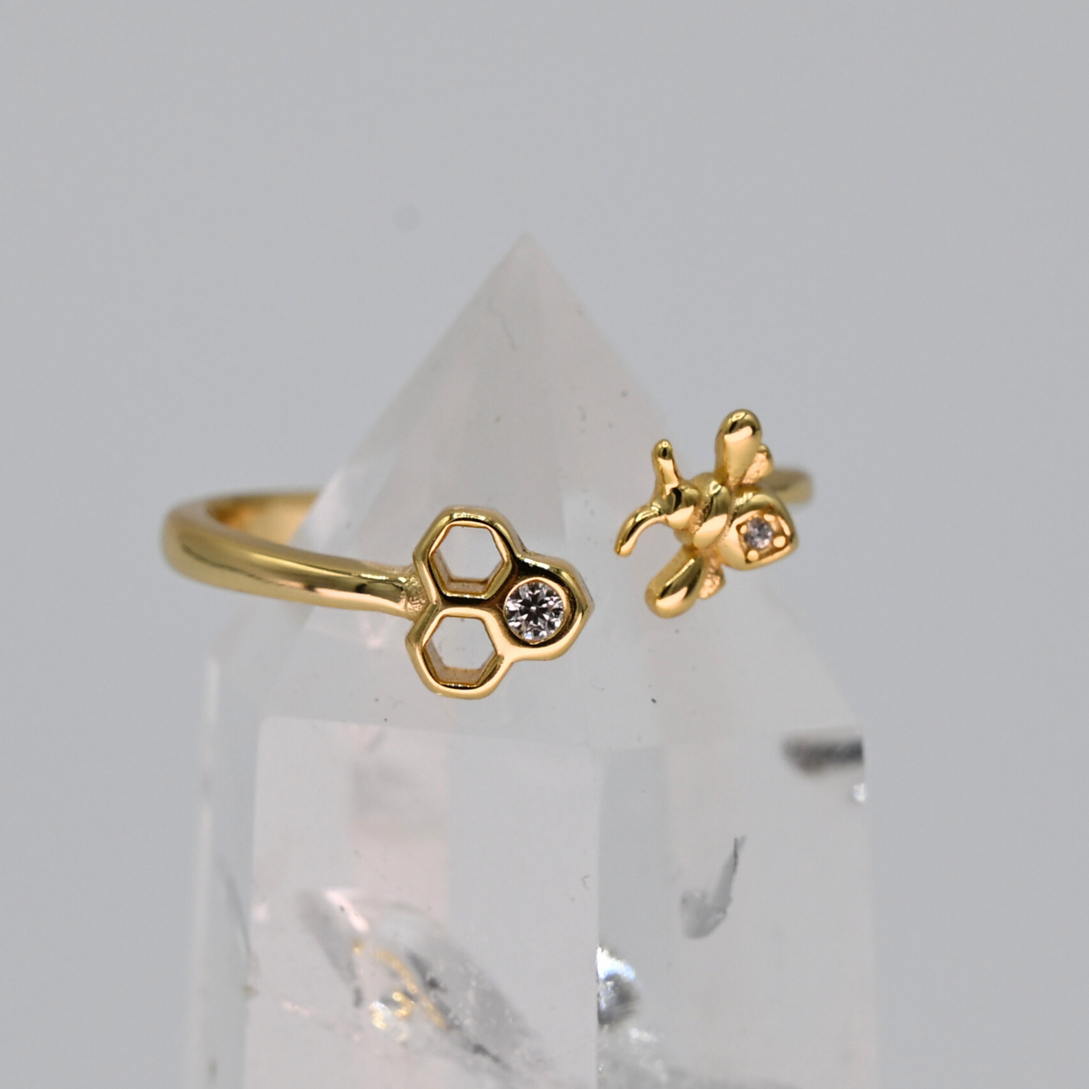 Adjustable bee and honeycomb ring in silver or gold with a bee charm and two CZ stones
