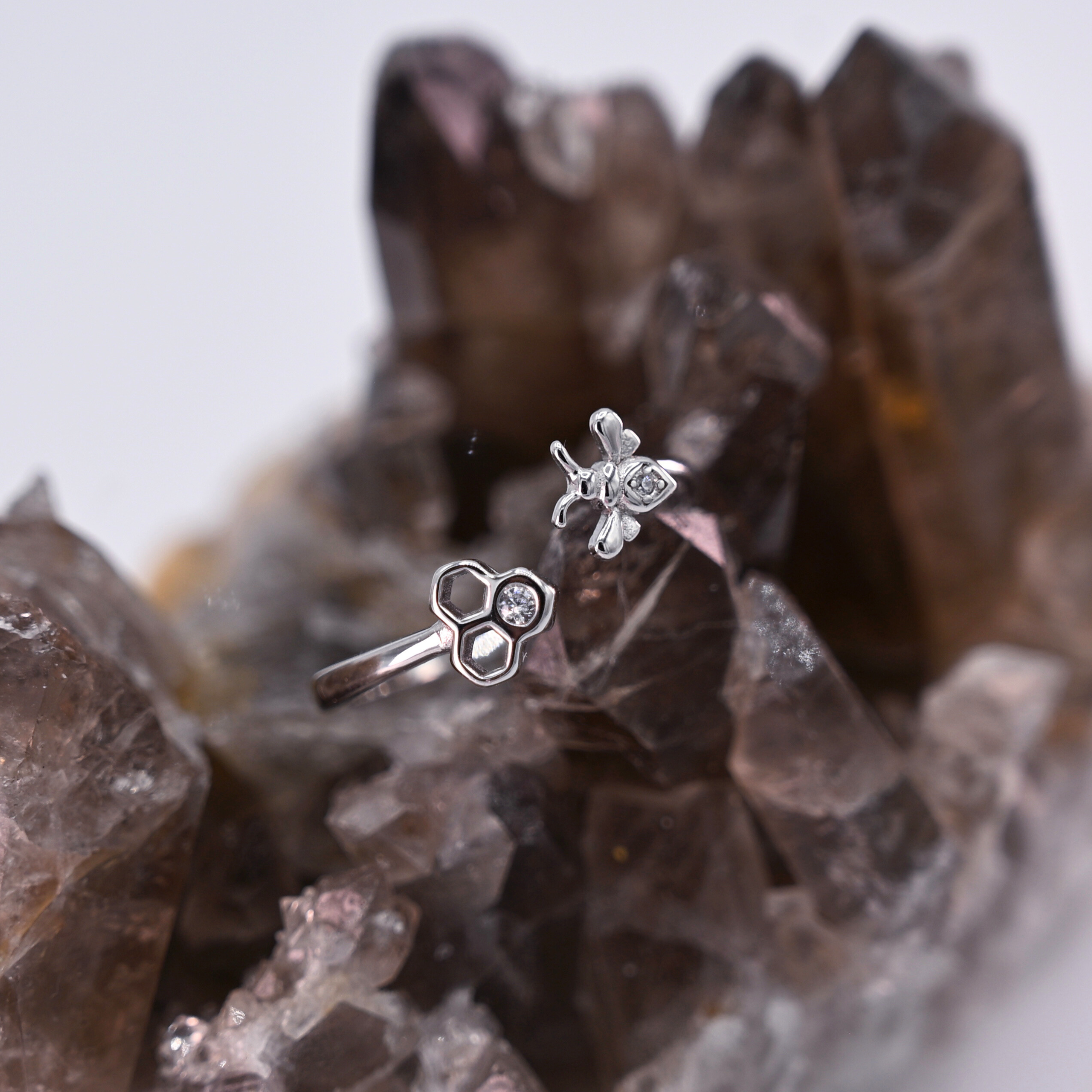 Adjustable bee and honeycomb ring in silver or gold with a bee charm and two CZ stones