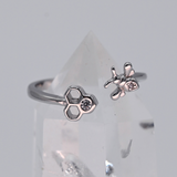 Adjustable bee and honeycomb ring in silver or gold with a bee charm and two CZ stones