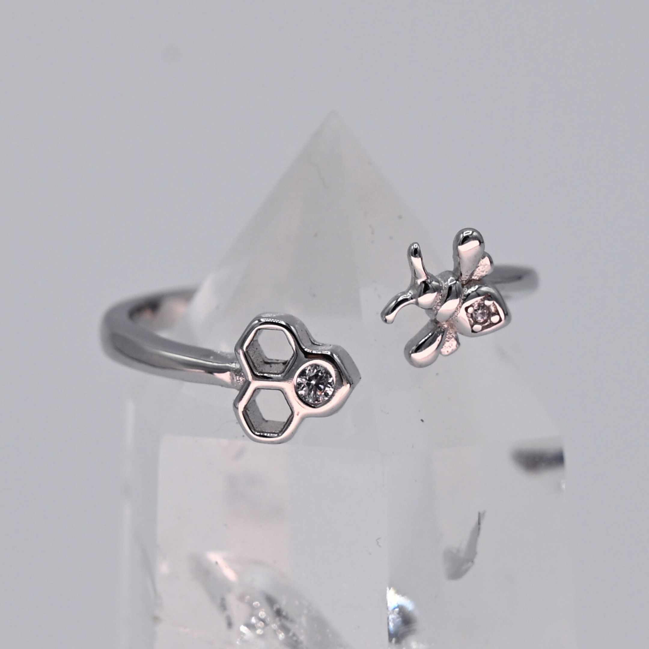 Adjustable bee and honeycomb ring in silver or gold with a bee charm and two CZ stones