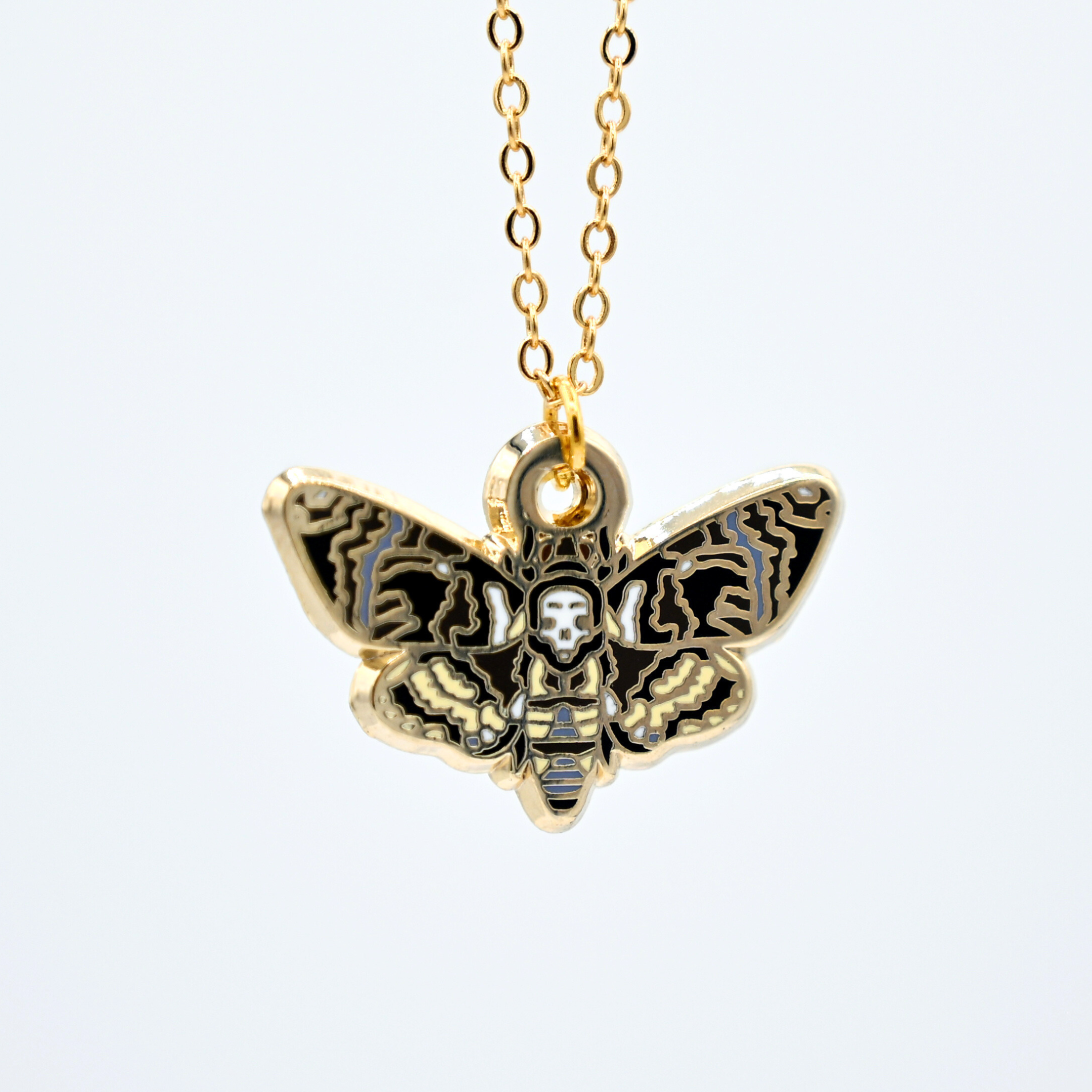 Death's-head hawkmoth necklace in silver or gold with a hawkmoth silhouette charm with the skull marking