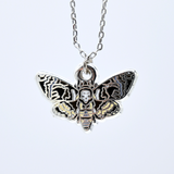 Death's-head hawkmoth necklace in silver or gold with a hawkmoth silhouette charm with the skull marking