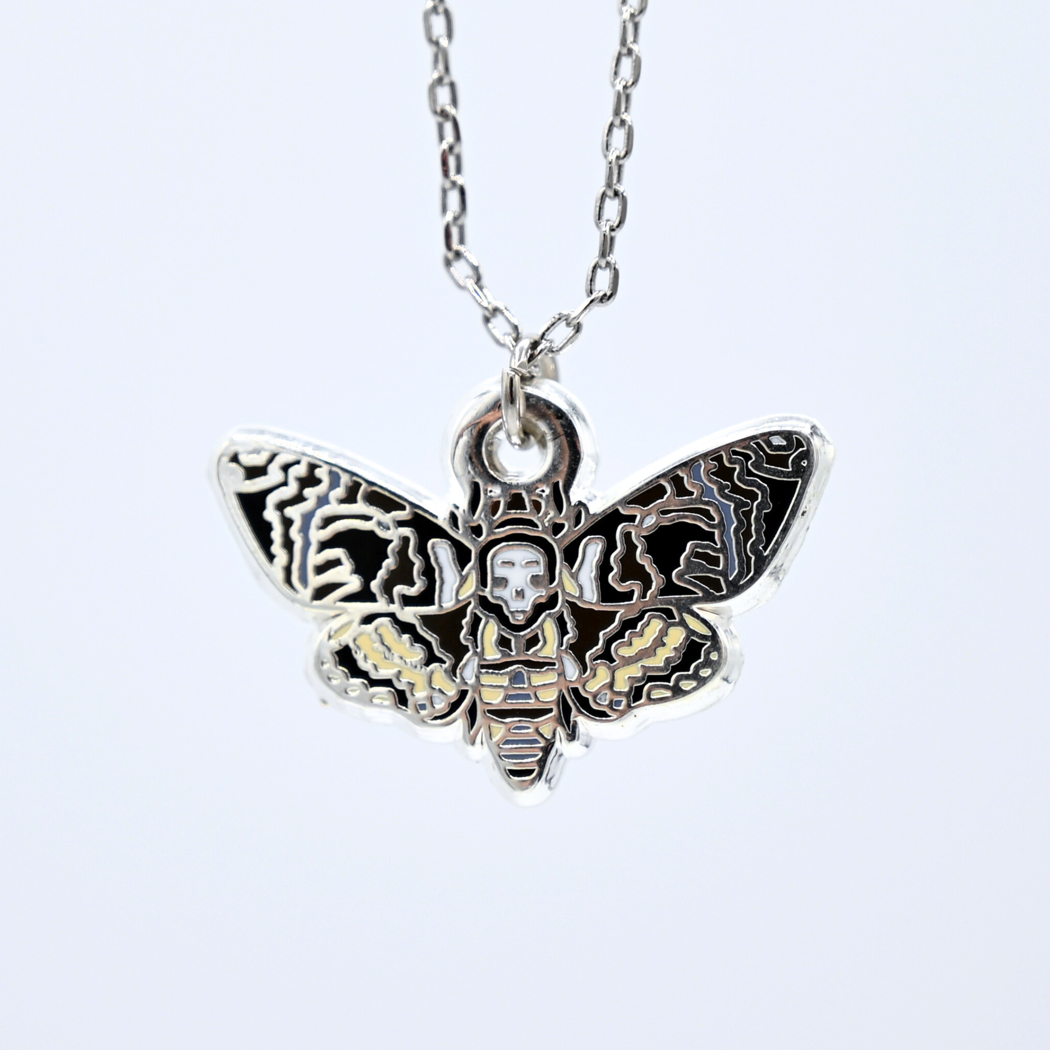 Death's-head hawkmoth necklace in silver or gold with a hawkmoth silhouette charm with the skull marking