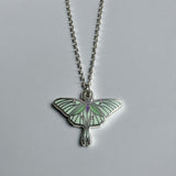 Green luna moth necklace in silver or gold with a luna moth silhouette charm