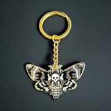Death's-head hawkmoth enamel keychain showing the signature skull marking in brown and gold