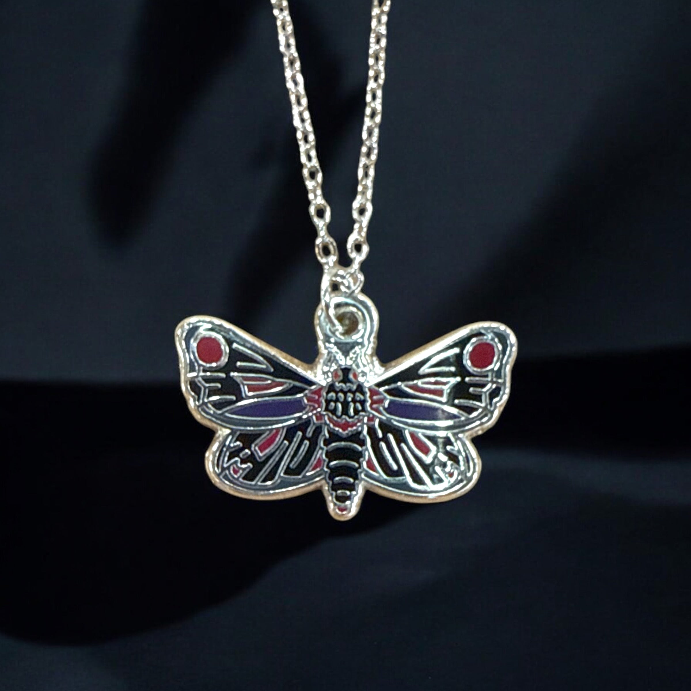 Mothman charm necklace in silver or gold with a Mothman cryptid silhouette charm