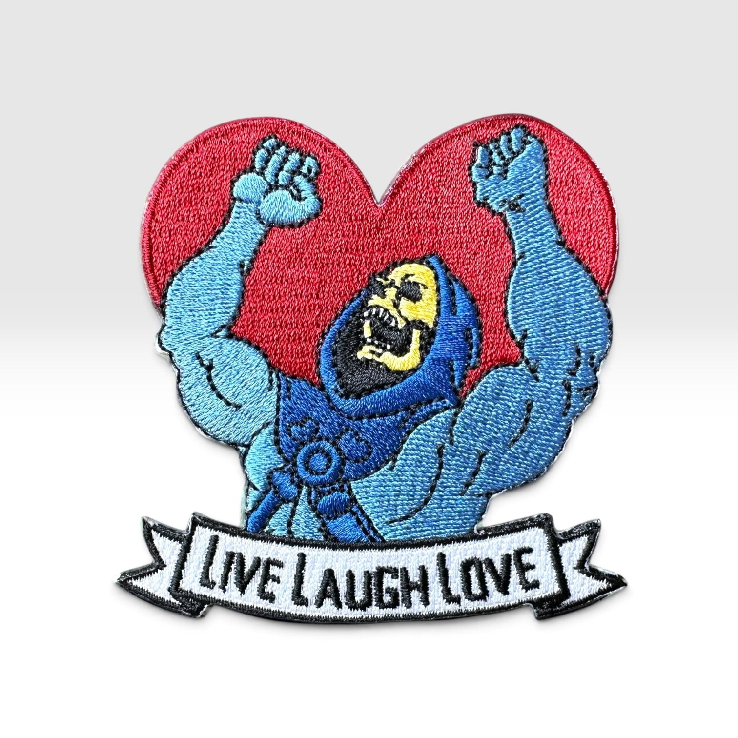 Embroidered patch with a laughing skeleton with the words "LIVE LAUGH LOVE"