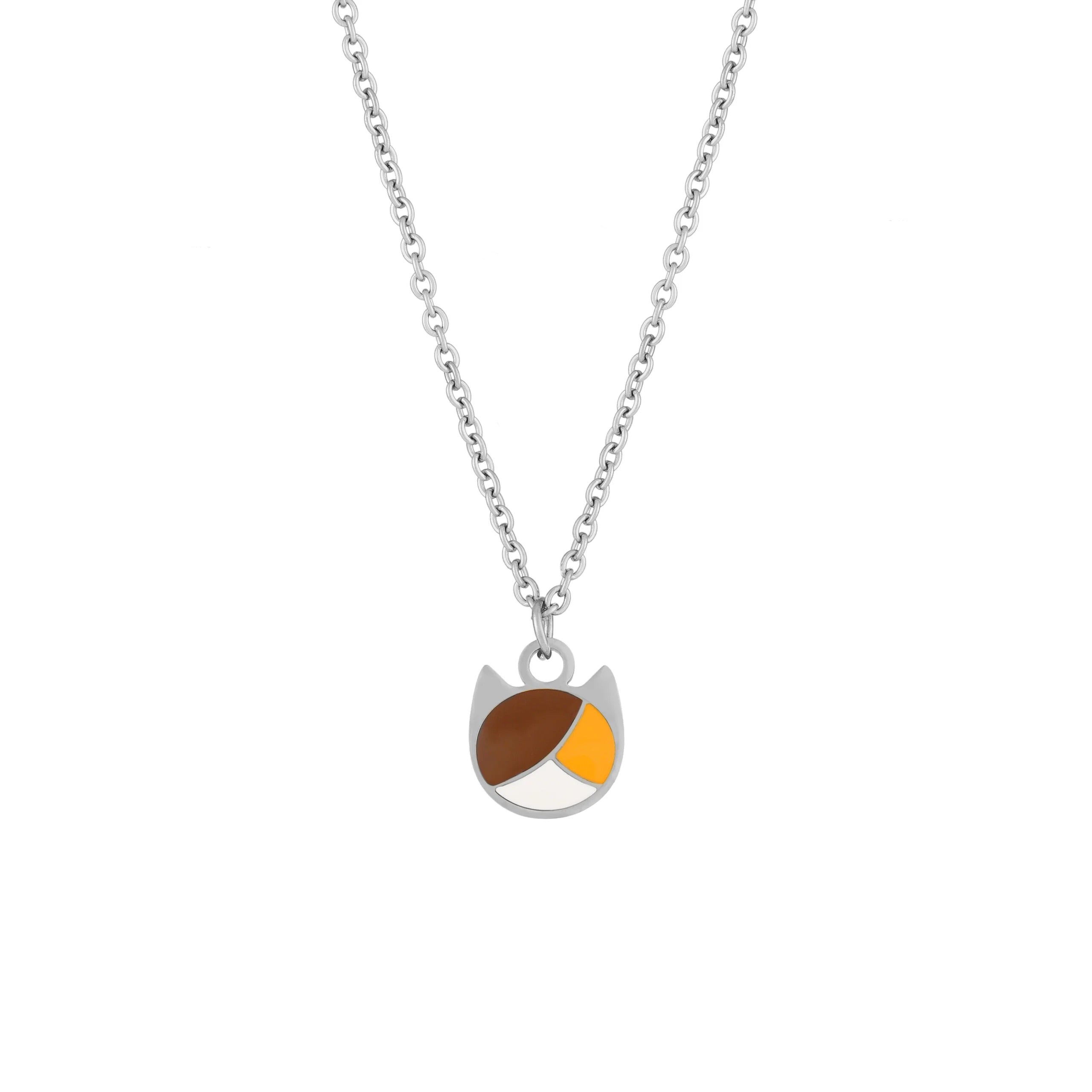 A silver chain necklace with a small pendant shaped like a cat face, featuring brown and yellow enamel details on a white background.