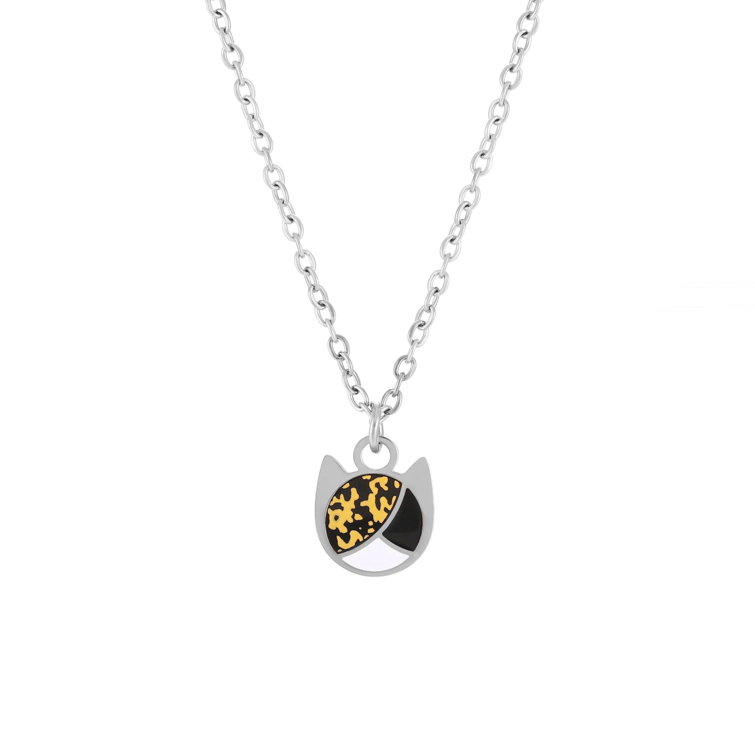 A silver chain necklace with a cat-shaped pendant featuring one eye in a black and yellow pattern and the other in solid white, set against a plain white background.
