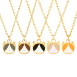 Five gold-tone necklaces with cat-face pendant charms are displayed against a white background. Each pendant is split into two colored sections, featuring color combinations of olive green and white, brown and white, black and white, pale lavender and white, and orange and white.