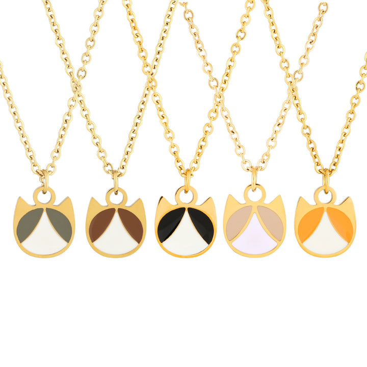 Five gold-tone necklaces with cat-face pendant charms are displayed against a white background. Each pendant is split into two colored sections, featuring color combinations of olive green and white, brown and white, black and white, pale lavender and white, and orange and white.